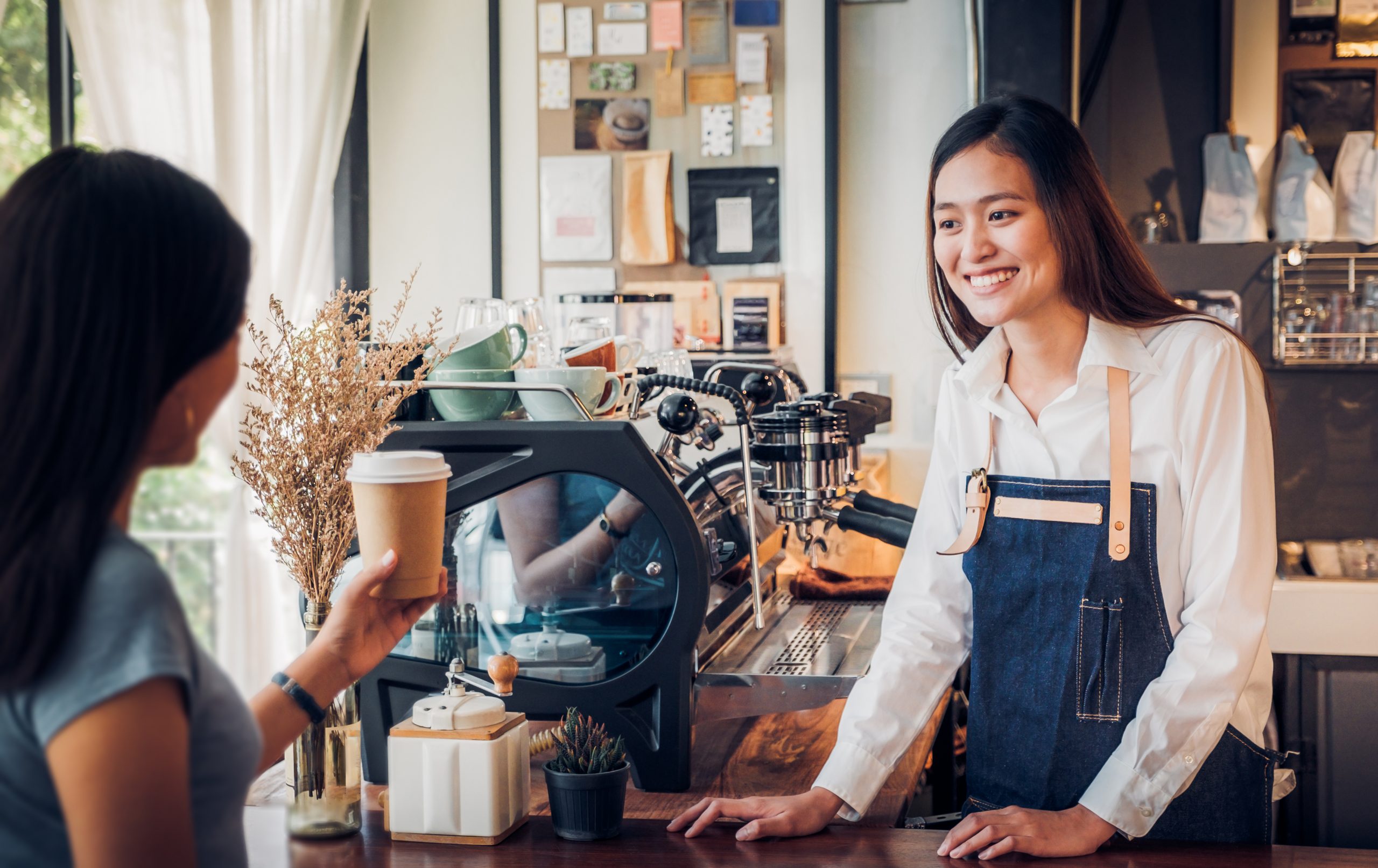 Asian woman barista and owner of coffee franchise small business concept.
