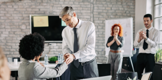 How can SMBs navigate low employee morale? Boss uplifting worker to improve employee morale