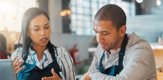 Streamlining your finances: expert tips for managing cash flows Small business owners discussing and managing cash flow in the cafe or coffee shop. Entrepreneurs having a financial discussion about the business finance strategy.